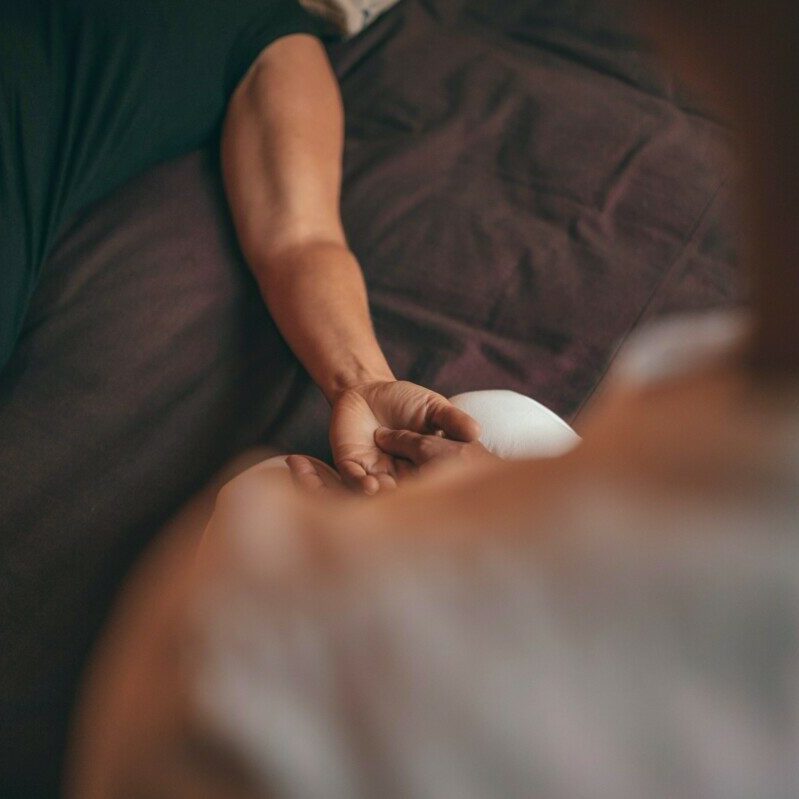 person in black shirt lying on bed