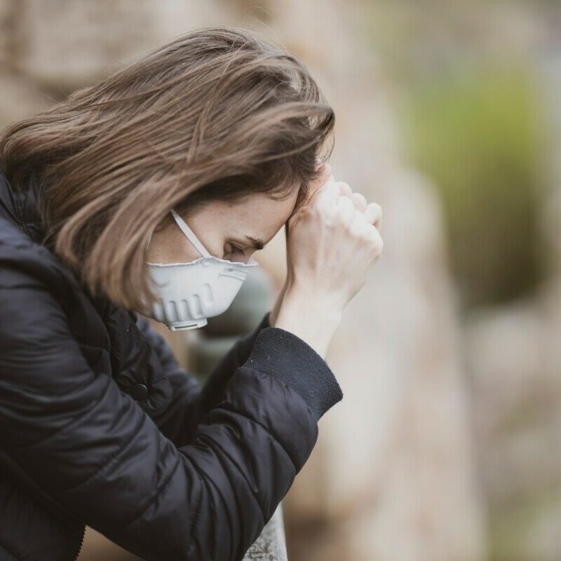 woman in black leather jacket wearing white framed eyeglasses covering her face