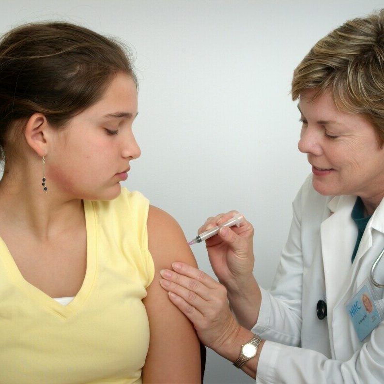 woman injecting girl's left arm