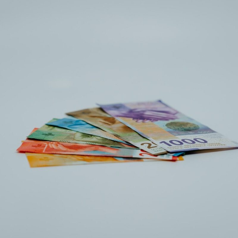 stack of banknotes on white surface