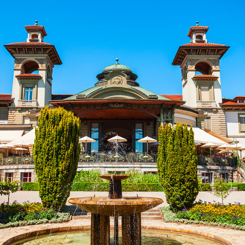 Fountain and historic building in the Esplanade of Montbenon park area of the city of Lausanne in Switzerland