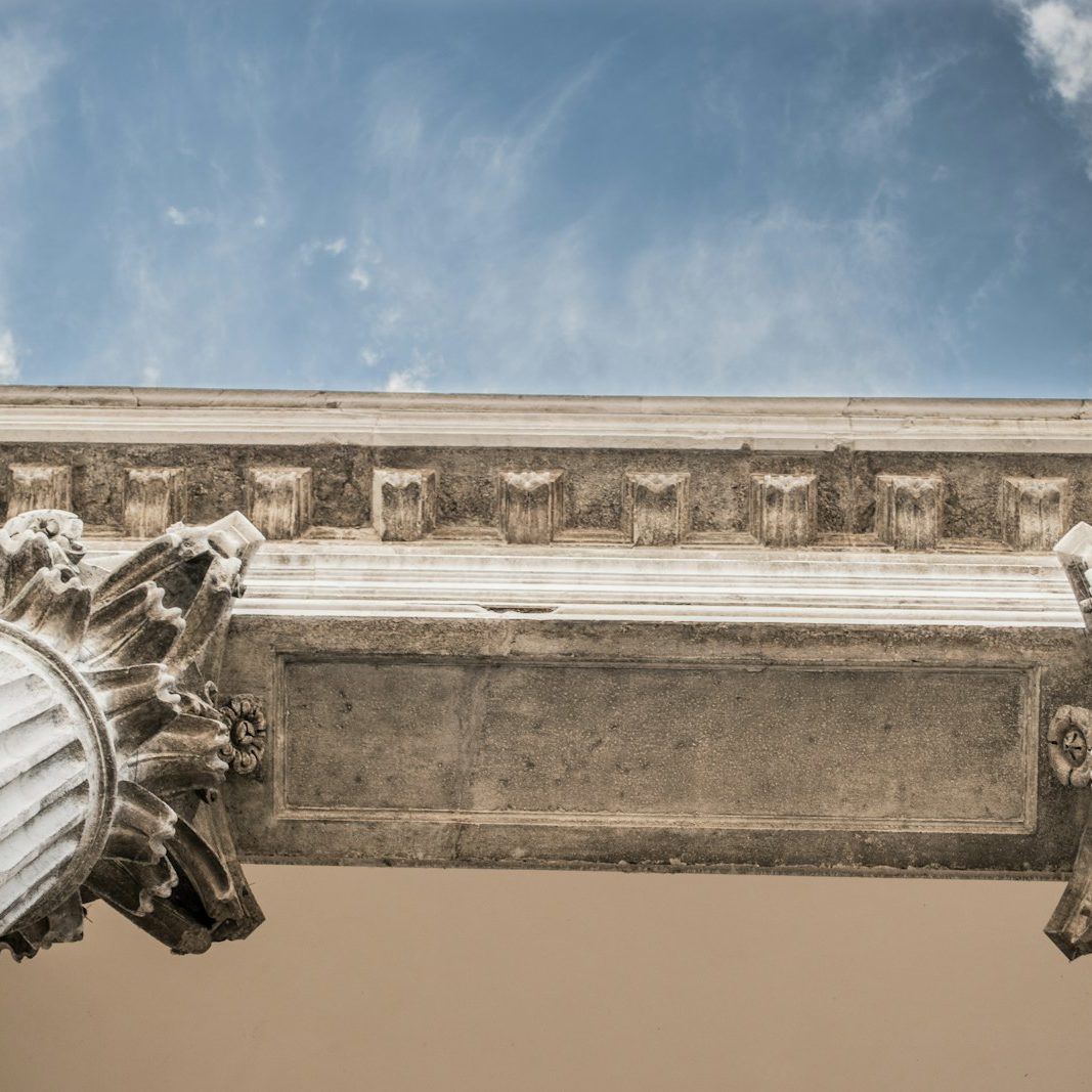 worm eye view of white concrete pillar during day time