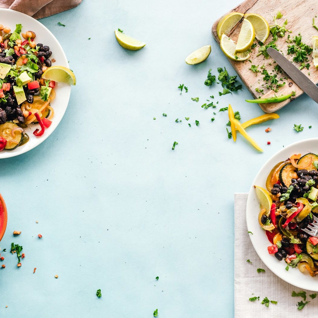 three bowls of salad dish with lemon on table