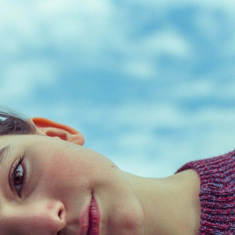 woman wearing red knit top