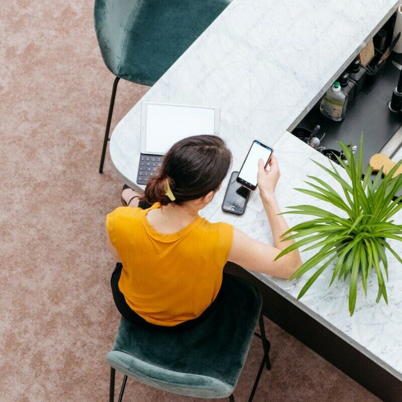 woman in yellow shirt sitting on chair