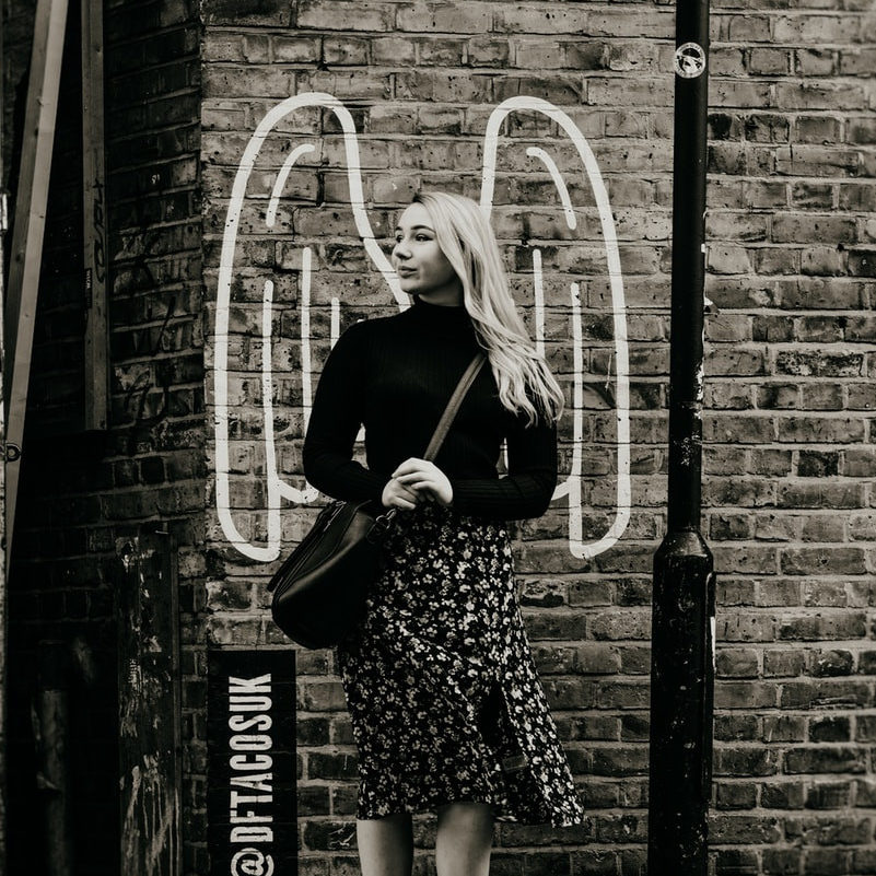 grayscale photo of woman standing looking at right side