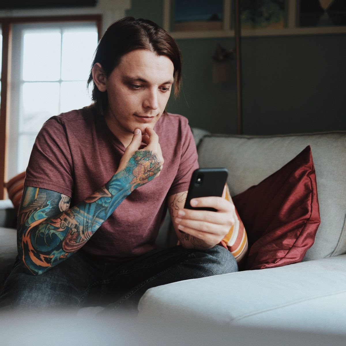 man using Android smartphone]