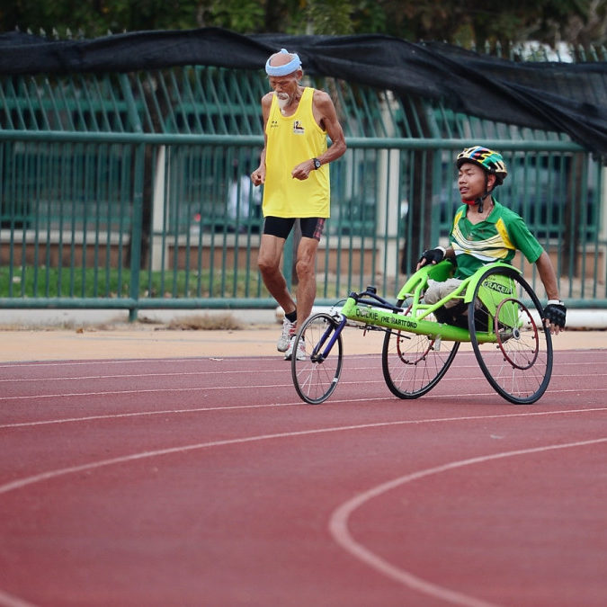 man using green wheelchair for walking